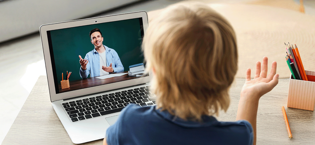 Student talking to teacher via distance learning on laptop.