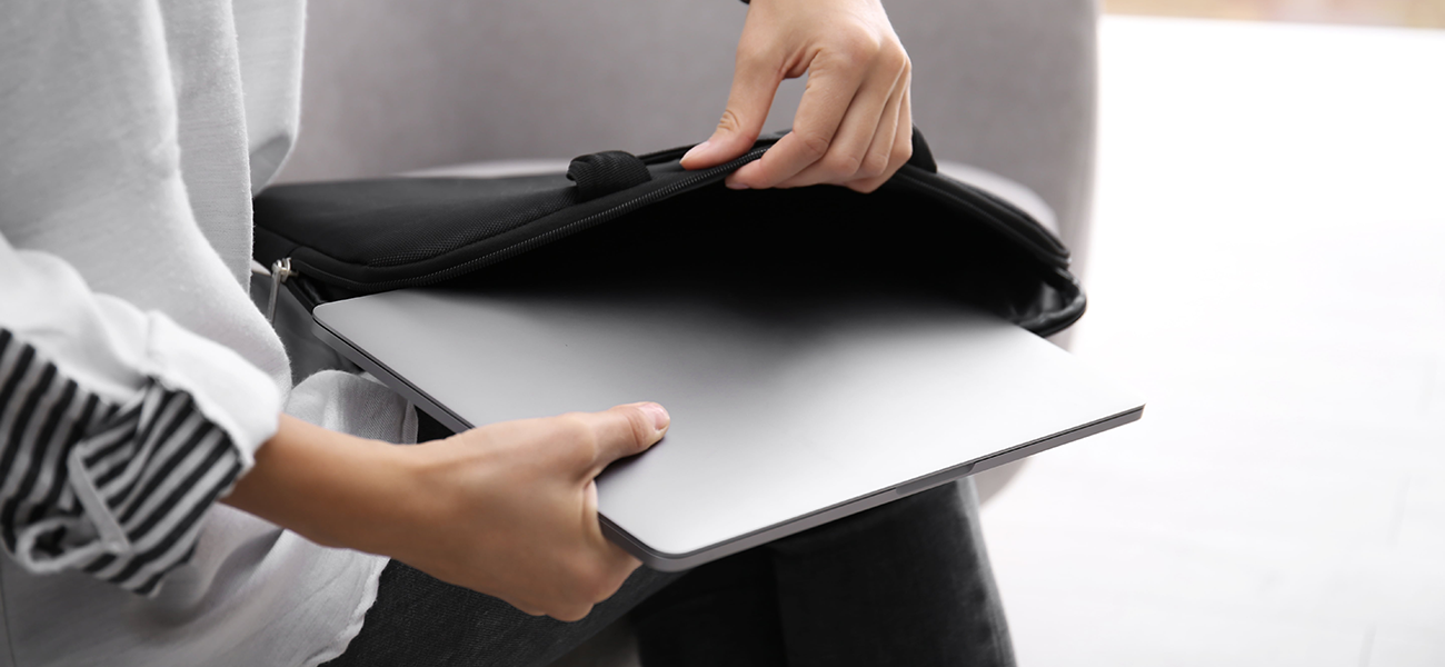A laptop being pulled out of its case.