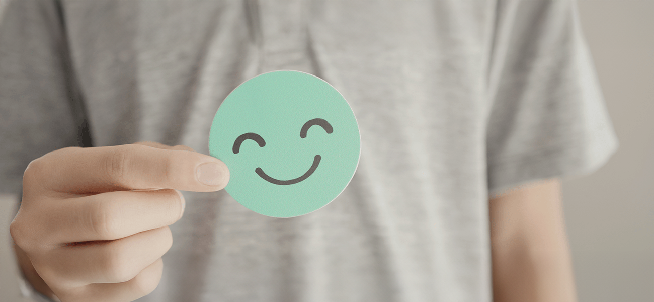 Image: One smiley happy face in green.