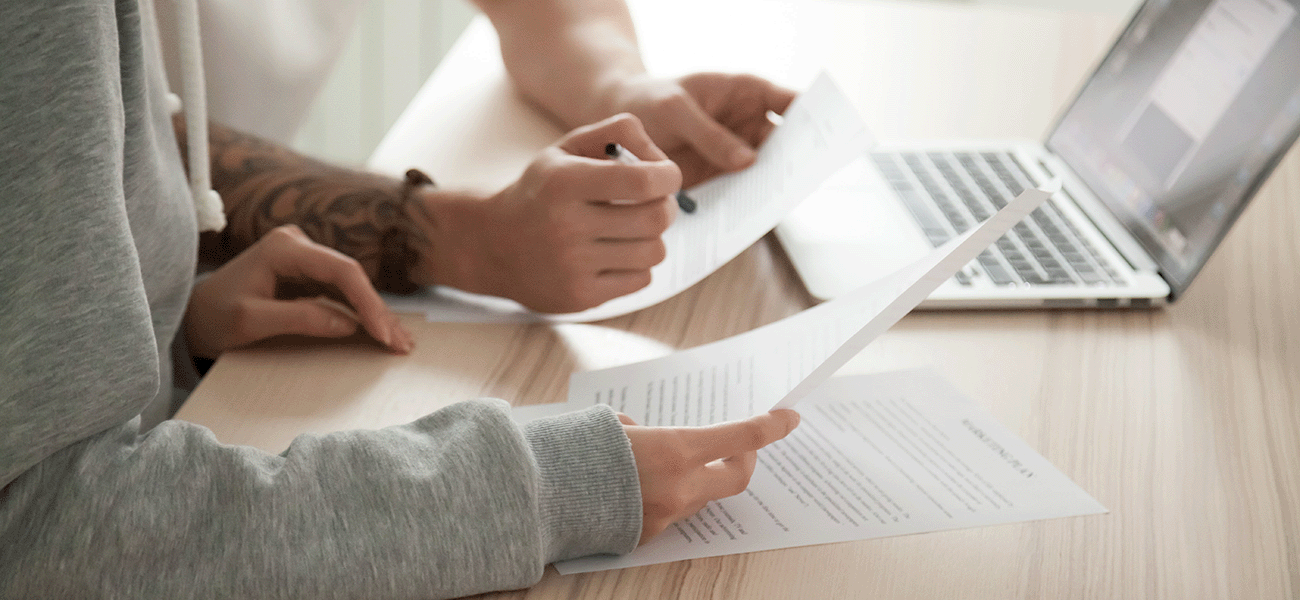 Parents reviewing insurance terms and conditions.
